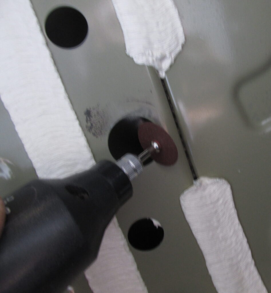 Grinding underside of car